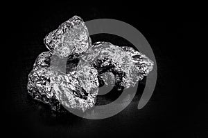 Various aluminum nuggets on black isolated background