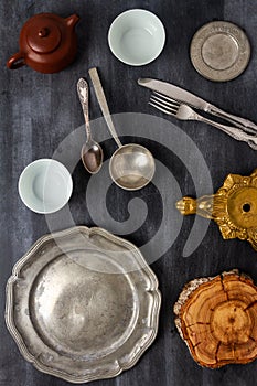 Various antique vintage dishes on black background