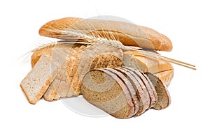 Various bakery products and wheat spikelets on a light backgroun