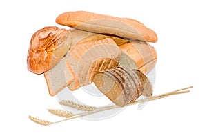 Various bakery products and wheat spikelets on a light backgroun