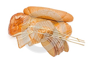 Various bakery products and wheat spikelets on a light backgroun