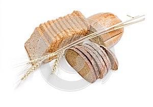 Various bakery products and wheat spikelets on a light backgroun