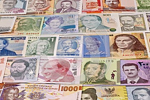 Various banknotes from different countries displayed on a table