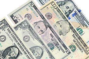 Various banknotes of US dollars lie one on another