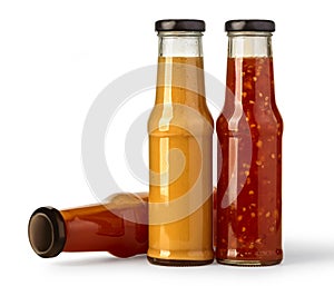 The various barbecue sauces in glass bottles photo