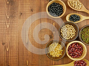Various beans on wooden table