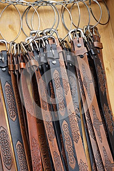 Various belts on market stall photo