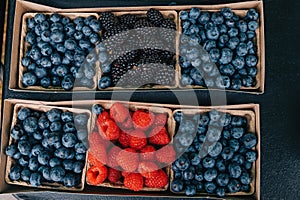 Various berries on the farmers market, blueberry, raspberry and blackberry