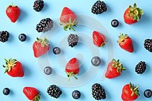 Various of berries on a pastel color background with copy space