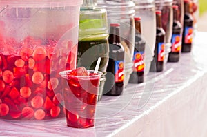 Various beverages on market, traditional come y bebe on plastic glass photo