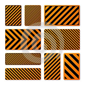 Various black and orange warning signs with diagonal lines. Attention, danger or caution sign, construction site signage