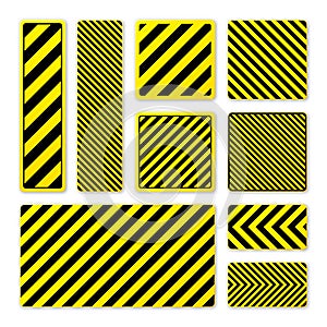 Various black and yellow warning signs with diagonal lines. Attention, danger or caution sign, construction site signage