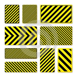 Various black and yellow warning signs with diagonal lines. Attention, danger or caution sign, construction site signage