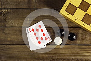 Various board games chess board, playing cards, dominoes.