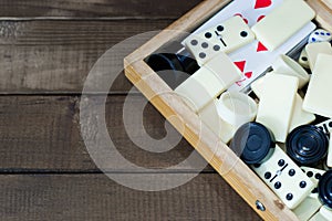 Various board games chess board, playing cards, dominoes.