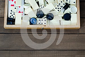 Various board games chess board, playing cards, dominoes.