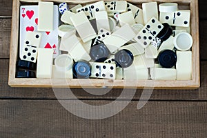 Various board games chess board, playing cards, dominoes.