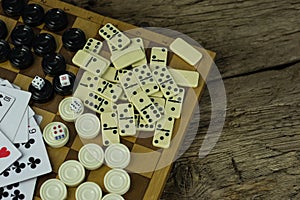 Various board games chess board, playing cards, dominoes.