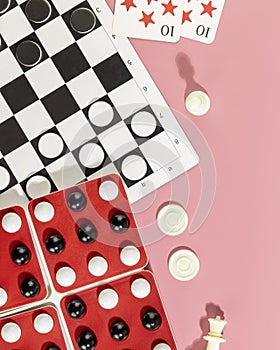 Various board games on a pink background
