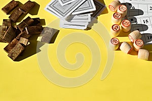 Various board games on a yellow background with a space for text. Board games in summer. Copy space. Flat lay, top view