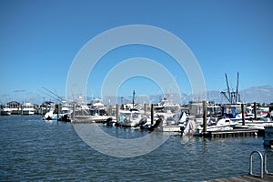 Various boats with outboard motors at the pier in the bay of the Atlantic Ocean