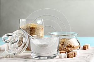 Various bowls with different sorts of sugar on table