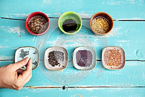 Various bowls, filled with water and microgreen sprouts in it