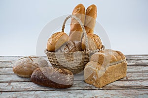 Various bread loaves on wooden surface