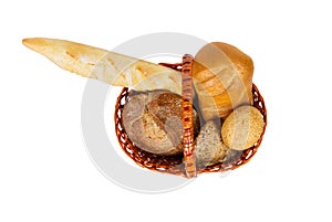 Various bread rolls in a basket isolateda white background. top view