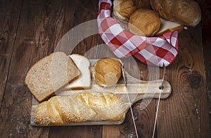 Various breads on a cutting board.