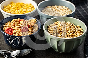 Various breakfast cereals in bowls.