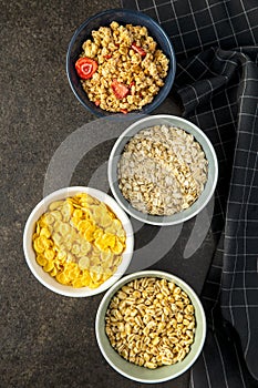 Various breakfast cereals in bowls. Puffed wheat and oatmeals