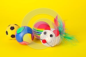 Various bright pet toys on yellow background