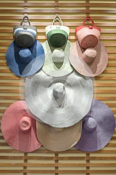 Various broad brimmed women`s straw hats, trendy. Summer vacation fashion accessories beach party concept. Top view flat