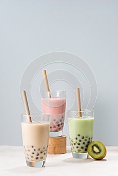 Various Bubble Tea glasses with drink straws isolated on white background