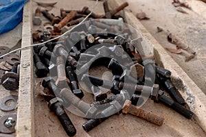 Various building construction screws scattered around a work site