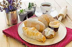 Various bun and bread on wood table