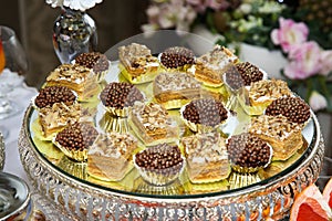 Various cakes on a round tray
