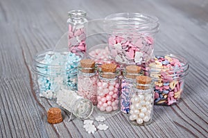 Various candy sprinkles in tiny storage cases