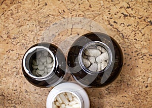 Various capsules and tablets with food additives or medicines in a jar