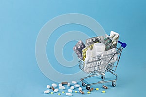Various capsules, tablets and medicine in shop trolley. Buy and shopping medicine concept.