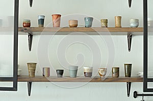 Various ceramic Japanese style teacup on shelf