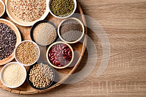 Various cereal, grain, bean, legume and seed in bowl on wooden background