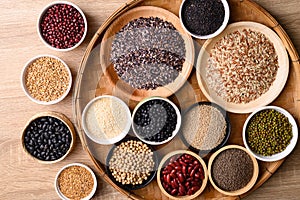 Various cereal, grain, bean, legume and seed in bowl on wooden background