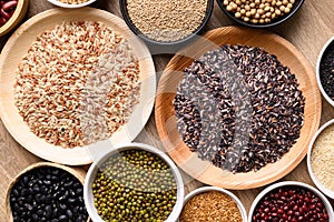 Various cereal, grain, bean, legume and seed in bowl on wooden background