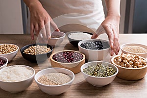 Various cereal grain in a bowl on wooden table