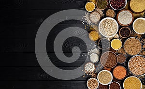 Cereals, grains, seeds and groats black wooden background photo