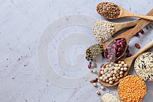 Various cereals in wooden spoons