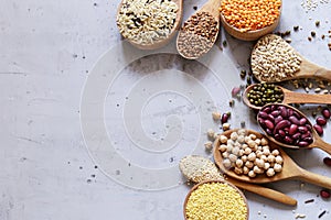 Various cereals in wooden spoons