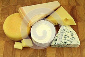 Various cheeses on a kitchen board